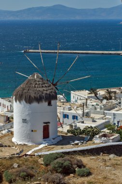 White windmill and Mykonos town, the island of Mykonos clipart