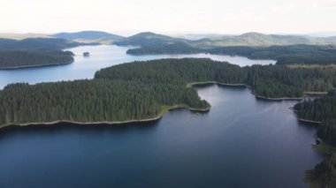 Aerial Summer view of Shiroka polyana (Wide meadow) Reservoir covered with ice, Pazardzhik Region, Bulgaria