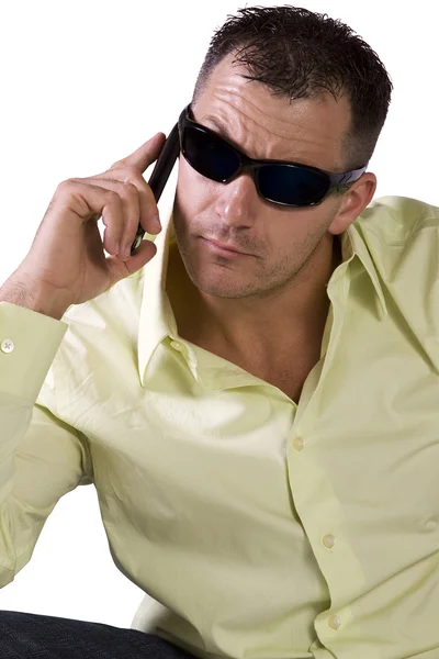 Man in trendy outfit with sunglasses talking on cell phone — Stock Photo, Image