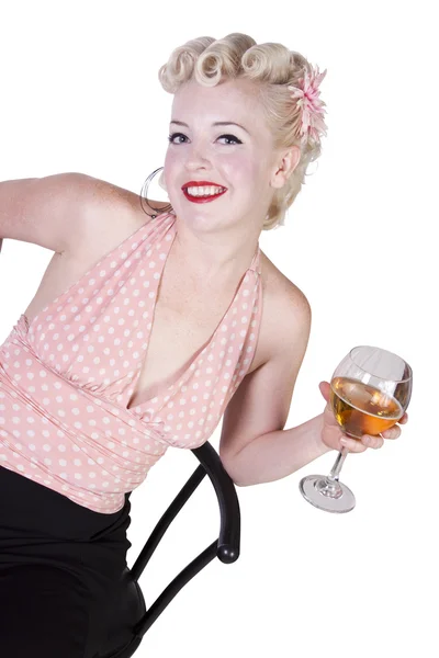 Woman in pin-up dress drinking on a chair - Isolated — Stock Photo, Image