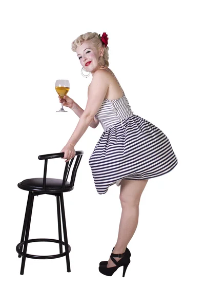 Beautiful pinup retro girl with wine enjoying cool air from fan — Stock Photo, Image