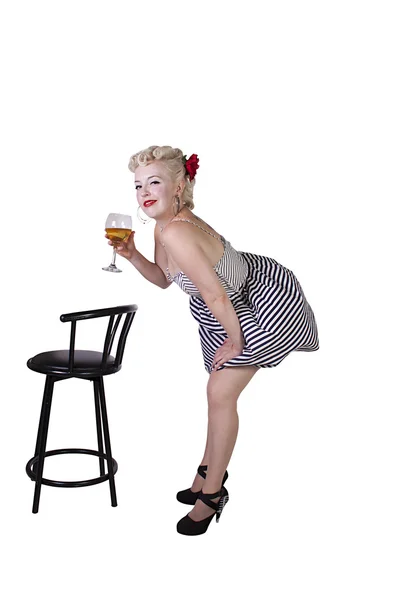 Beautiful pinup retro girl with wine enjoying cool air from fan — Stock Photo, Image