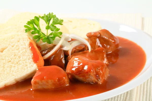 Pork meat in tomato sauce with dumplings — Stock Photo, Image