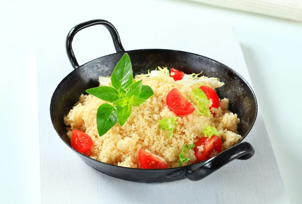 Couscous with salad greens and tomato — Stock Photo, Image