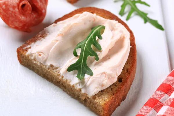 Crispy bread with spread and salami — Stock Photo, Image