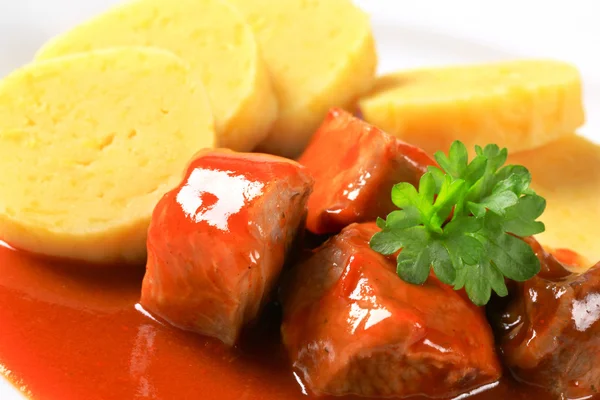 Pork in tomato sauce with potato dumplings — Stock Photo, Image