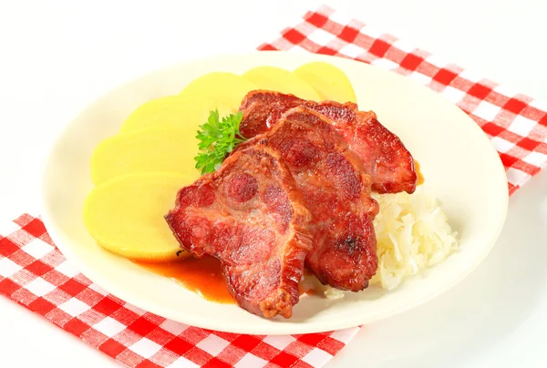 Pork with potato dumplings and sauerkraut — Stock Photo, Image