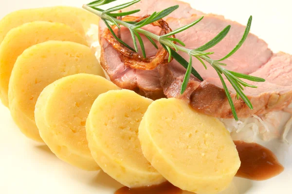 Pork with potato dumplings and white cabbage — Stock Photo, Image