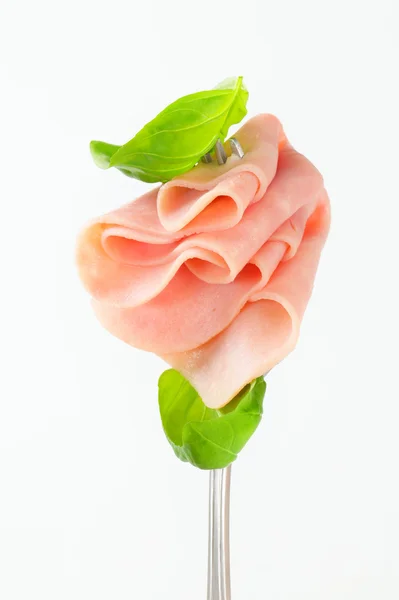 Slices of ham on fork — Stock Photo, Image