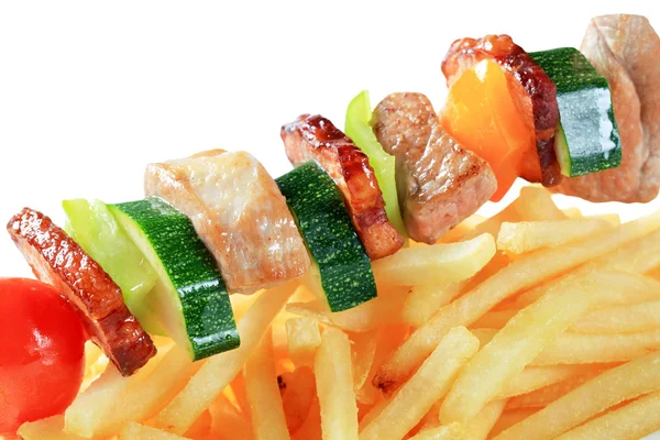 Pork skewer and French fries — Stock Photo, Image