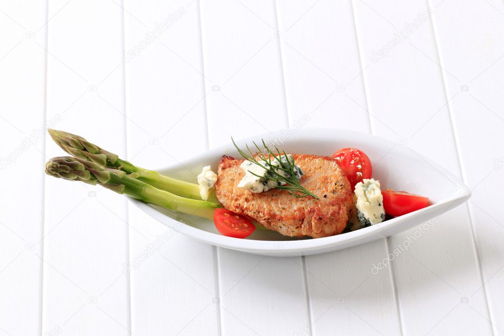 Pork chop with blue cheese and vegetables
