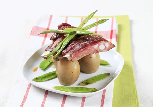 Varkensribbetjes en aardappelen — Stockfoto