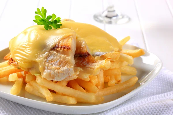 Cheese topped fish fillets with French fries — Stock Photo, Image