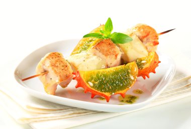 Chicken and aubergine skewer with pesto and horned melon clipart