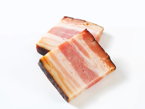 Slices of smoked bacon - studio shot — Stock Photo, Image