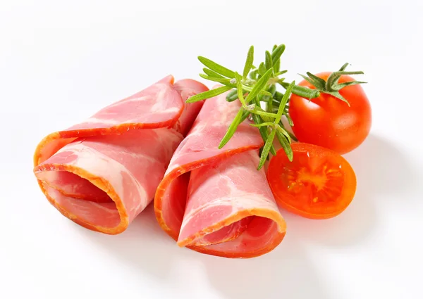 Slices of smoked pork - rolled up — Stock Photo, Image