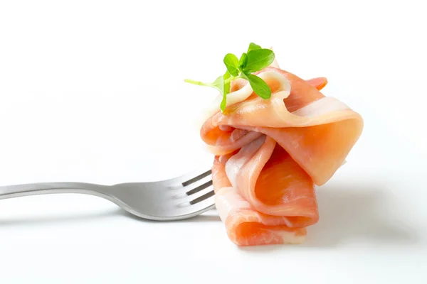 Prosciutto on a fork — Stock Photo, Image