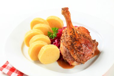 Roast duck with potato dumplings and red cabbage clipart