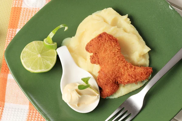 Fried dinosaur-shaped nugget with mashed potato — Stock Photo, Image