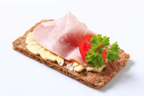 Brown crisp bread with ham — Stock Photo, Image