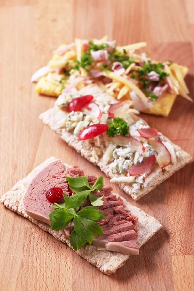 Crispbread with various savory toppings — Stock Photo, Image
