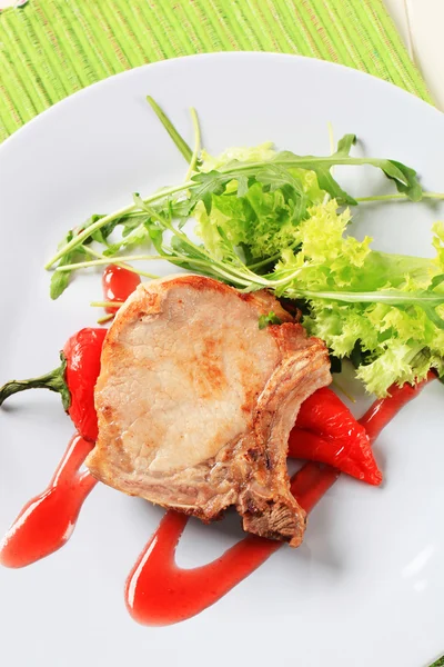 Pork chop with hot sauce — Stock Photo, Image