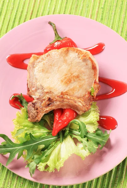 Pork chop with hot sauce — Stock Photo, Image