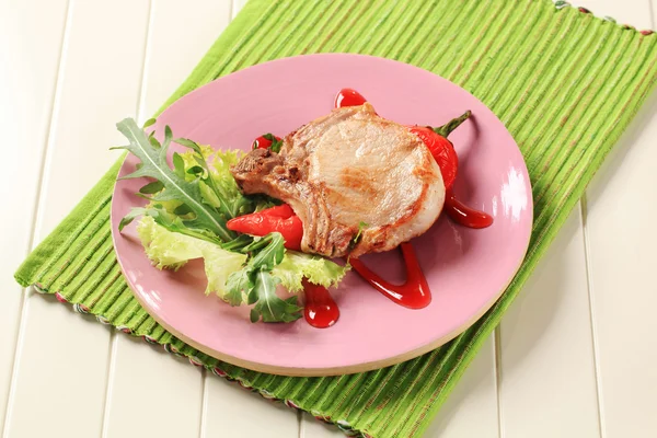 Pork chop with hot sauce — Stock Photo, Image