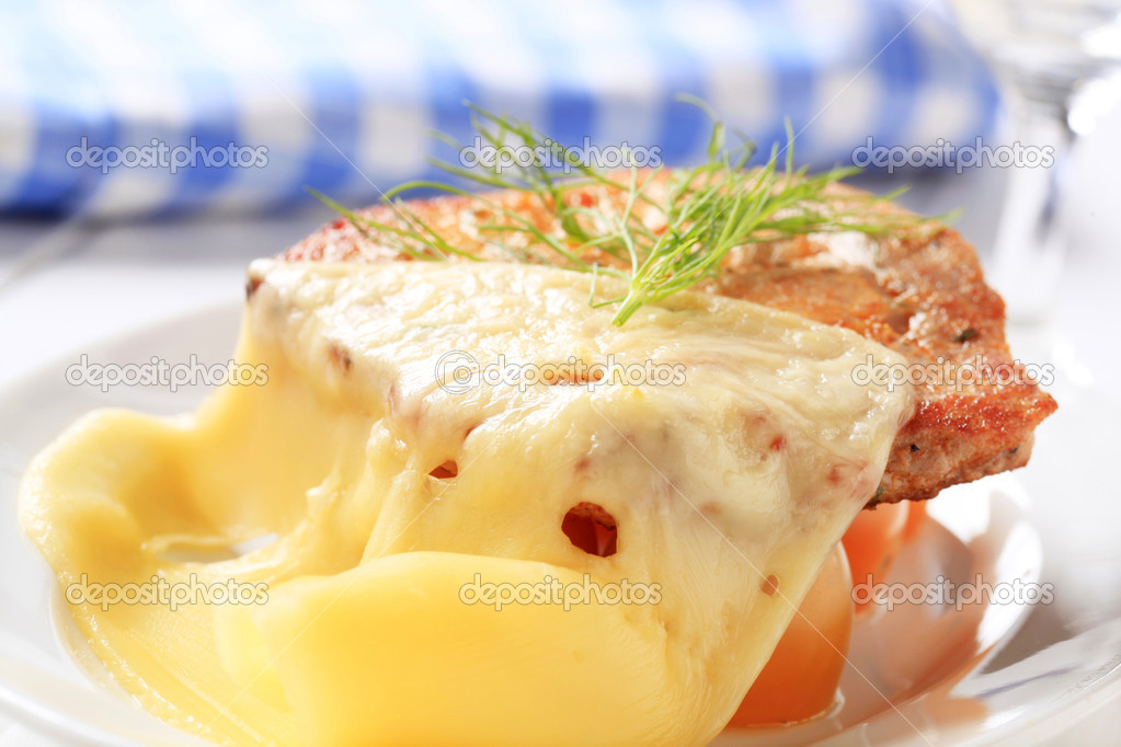 Marinated pork chop topped with Swiss cheese