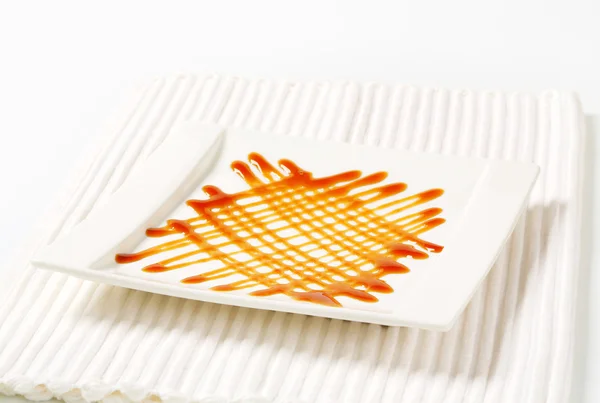 Caramel drizzle sauce decoration — Stock Photo, Image