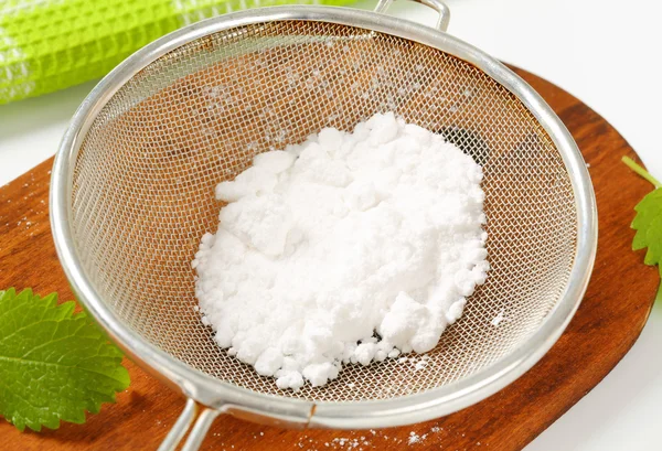 Powdered sugar in a sieve — Stock Photo, Image