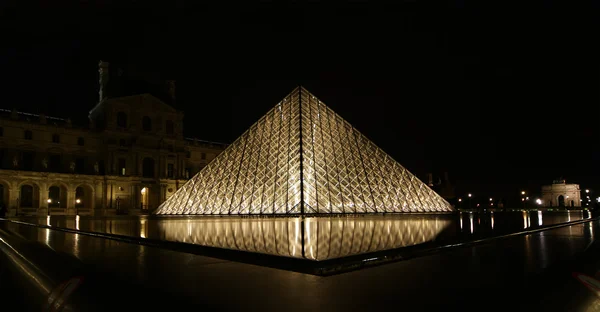 法国的卢浮宫玻璃金字塔下的 （通过夜) — 图库照片