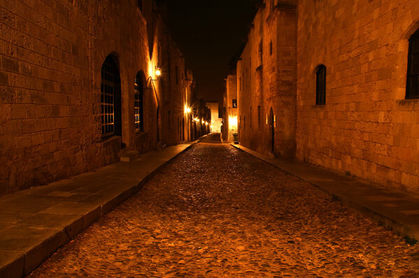 Medieval Avenue of the Knights at night, a cobblestone street in Rhodes Citadel , Greece