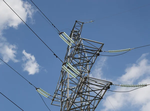 Strommasten und Stromleitung gegen blauen Himmel und Wolken — Stockfoto