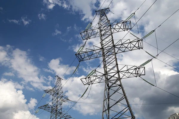 Electricity pylons and line against the blue sky and clouds — Stock Photo, Image