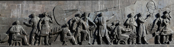 Detail from the titanium obelisk representing the Soviet succes dream, featuring scientists and engineers hard at work. Monument of Sovjet space flight, near VDNK exhibition center, Moscow, Russia