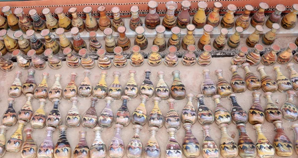 Traditional local souvenirs in Jordan- bottles with sand and shapes of desert and camels — Stock Photo, Image