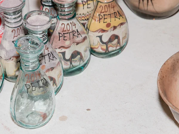 Traditional local souvenirs in Jordan- bottles with sand and shapes of desert and camels — Stock Photo, Image
