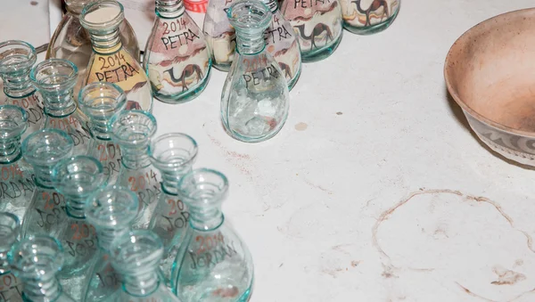 Traditional local souvenirs in Jordan- bottles with sand and shapes of desert and camels — Stock Photo, Image