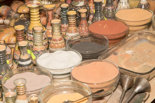 Traditional local souvenirs in Jordan- bottles with sand and shapes of desert and camels — Stock Photo, Image