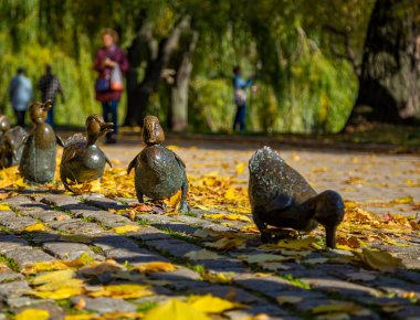Parktaki yol ördekleri anıtı Novodevichy göletleri sonbaharda Novodevichy manastırında ördek yavruları ile bir ördek heykeli. Moskova, Rusya