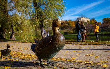 Parktaki yol ördekleri anıtı Novodevichy göletleri sonbaharda Novodevichy manastırında ördek yavruları ile bir ördek heykeli. Moskova, Rusya