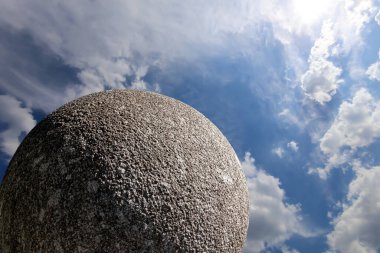 Gökyüzünün arka planında bulutlu büyük granit top 