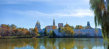 Novodevichy manastırı (Bogoroditse-Smolensky manastırı) ve güneşli bir sonbahar gününde büyük Novodevichy göleti manzarası (panoramik manzara). Moskova, Rusya. UNESCO dünya mirası sahası