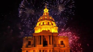 Celebratory colorful fireworks over the Les Invalides (The National Residence of the Invalids) at night. Paris, France