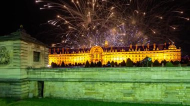 Celebratory colorful fireworks over the Les Invalides (The National Residence of the Invalids) at night. Paris, France