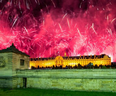 Celebratory colorful fireworks over the Les Invalides (The National Residence of the Invalids) at night. Paris, France      
