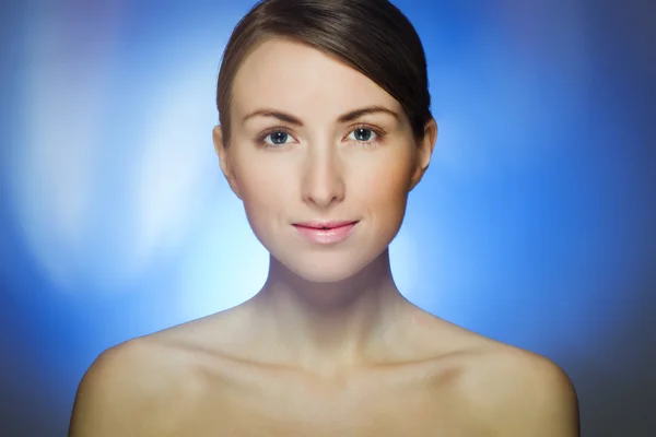 Portrait of pretty young woman on blue background. Clean beauty — Stock Photo, Image