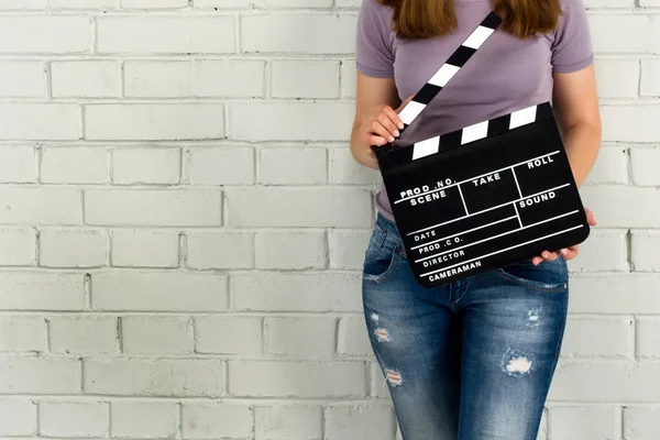 Woman holding a clapboard — Stock Photo, Image