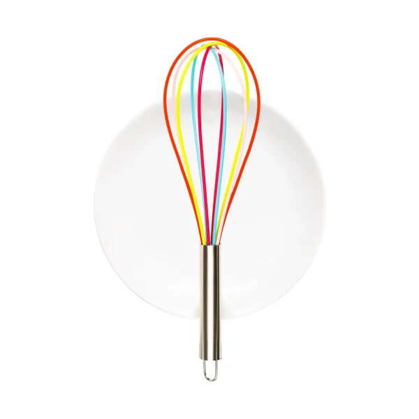 White plate with colorful whisk — Stock Photo, Image